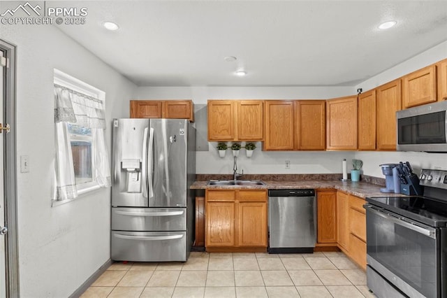2246 Bison Dr, Colorado Springs, CO 80911 - kitchen featuring a sink, light tile patterned flooring, dark countertops, and stainless steel appliances