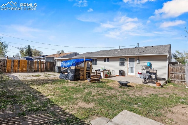 2246 Bison Dr, Colorado Springs, CO 80911 - rear view of property featuring a fire pit, a fenced backyard, and a patio area