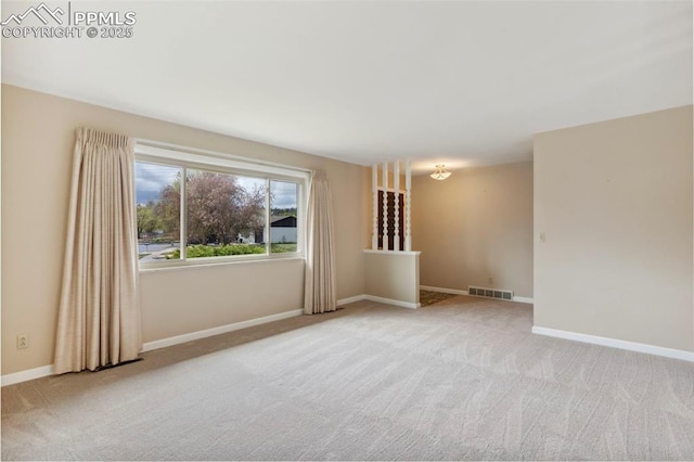 empty room with visible vents, carpet flooring, and baseboards