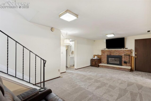 unfurnished living room with stairs, baseboards, light carpet, and a fireplace