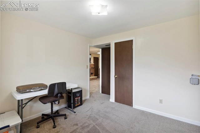 carpeted office space featuring baseboards