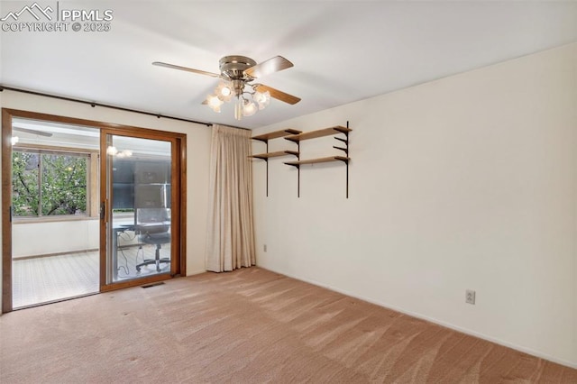 empty room with a ceiling fan, baseboards, light colored carpet, and visible vents