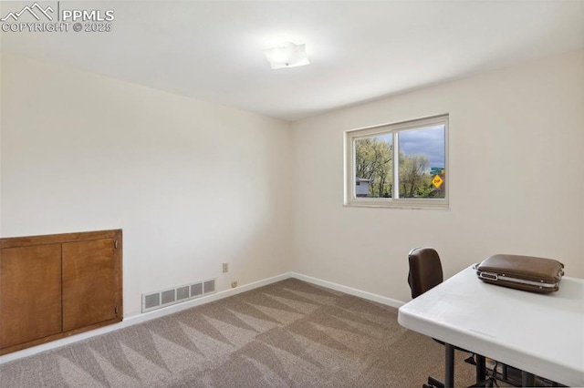 unfurnished office featuring baseboards, light colored carpet, and visible vents
