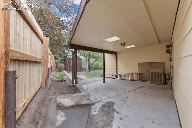 view of patio / terrace with central air condition unit and fence