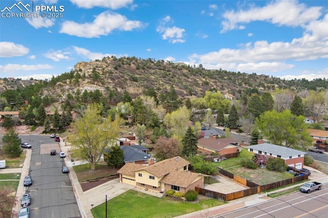 drone / aerial view featuring a residential view and a mountain view