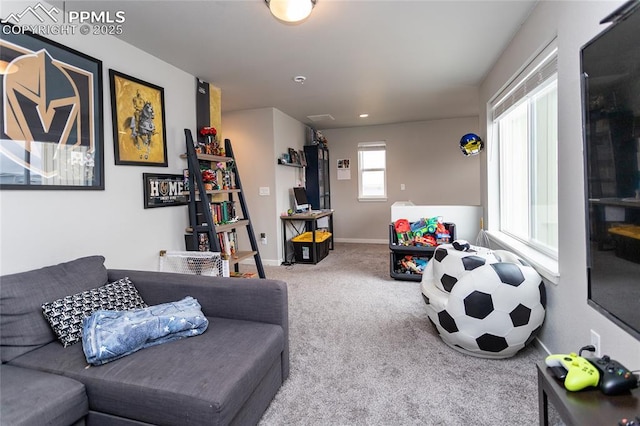 carpeted living room featuring baseboards
