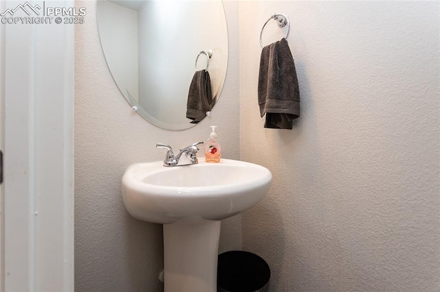 bathroom with a sink and a textured wall