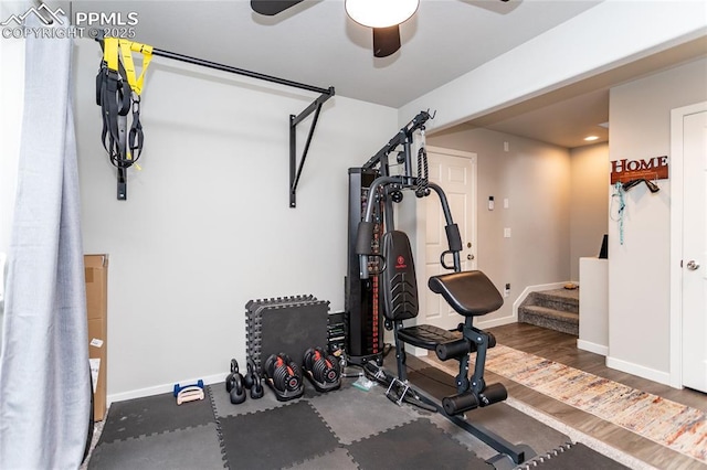 exercise room featuring wood finished floors, baseboards, and ceiling fan