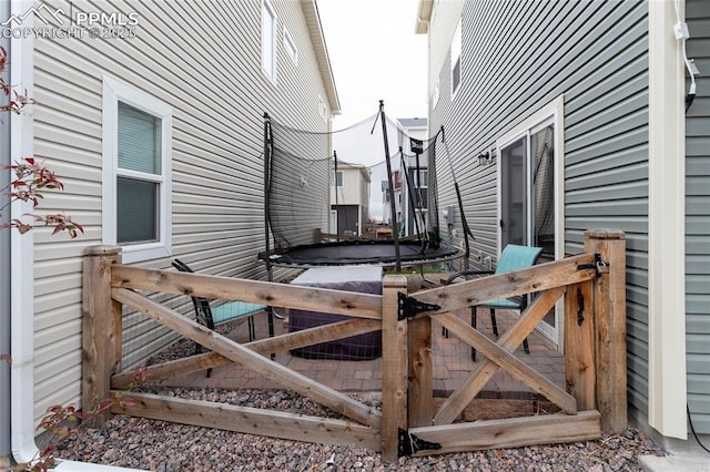 view of side of property with a trampoline