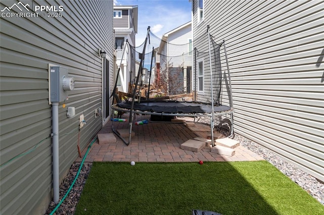 view of yard with a patio area and a trampoline
