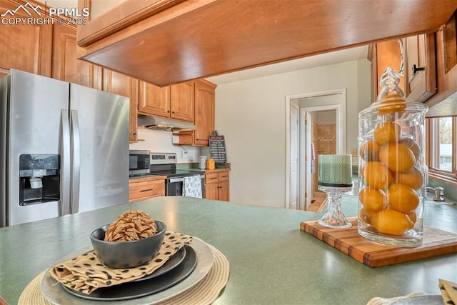 kitchen featuring under cabinet range hood and appliances with stainless steel finishes