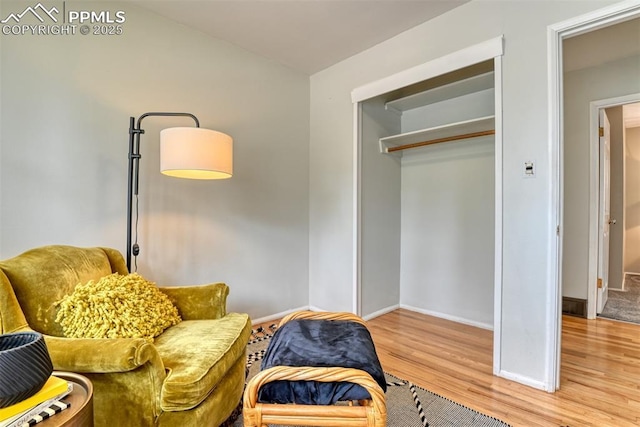 sitting room featuring baseboards and wood finished floors