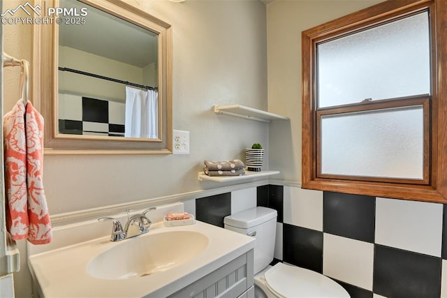 full bathroom featuring vanity and toilet