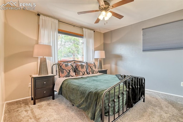 carpeted bedroom featuring baseboards and ceiling fan