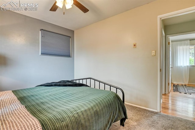 carpeted bedroom with baseboards and a ceiling fan