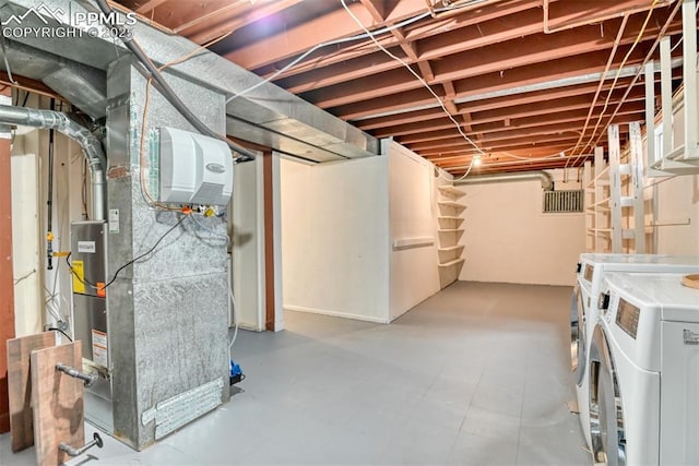unfinished below grade area with separate washer and dryer and heating unit