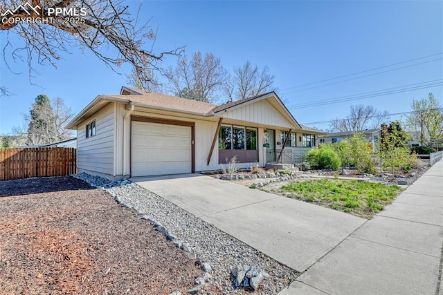 ranch-style house with a garage, fence, covered porch, and concrete driveway