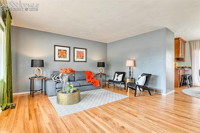 living room featuring baseboards and wood finished floors
