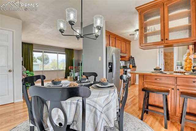 dining room featuring light wood-style flooring and a chandelier