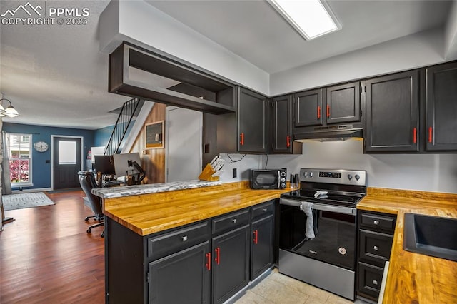 3319 Queen Anne Way, Colorado Springs, CO 80917 - kitchen featuring electric range, a peninsula, butcher block countertops, open floor plan, and under cabinet range hood