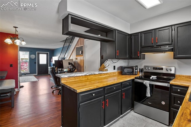 3319 Queen Anne Way, Colorado Springs, CO 80917 - kitchen featuring stainless steel electric range, dark cabinetry, a peninsula, under cabinet range hood, and butcher block counters