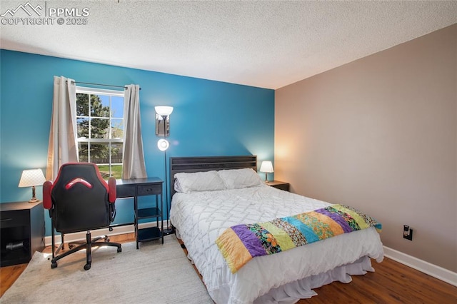 3319 Queen Anne Way, Colorado Springs, CO 80917 - bedroom featuring baseboards, a textured ceiling, and wood finished floors