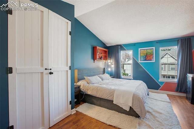 3319 Queen Anne Way, Colorado Springs, CO 80917 - bedroom featuring multiple windows, wood finished floors, and lofted ceiling