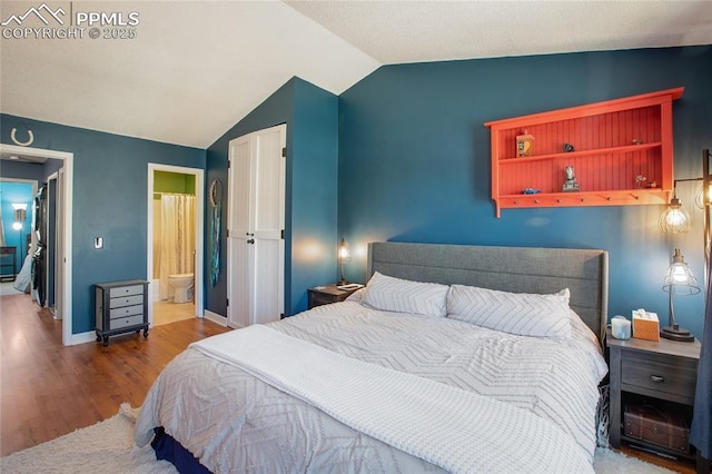 3319 Queen Anne Way, Colorado Springs, CO 80917 - bedroom featuring baseboards, vaulted ceiling, wood finished floors, and ensuite bath