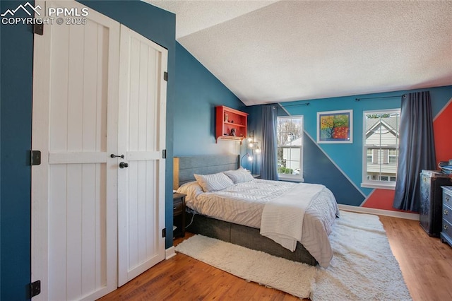 3319 Queen Anne Way, Colorado Springs, CO 80917 - bedroom with a textured ceiling, wood finished floors, and vaulted ceiling
