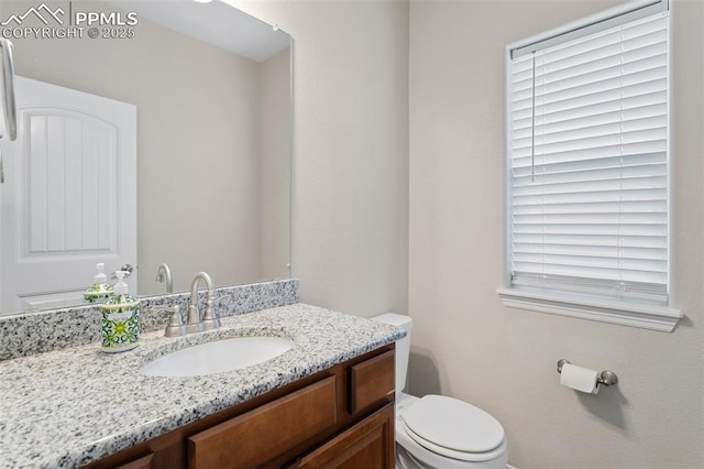 half bath featuring toilet and vanity