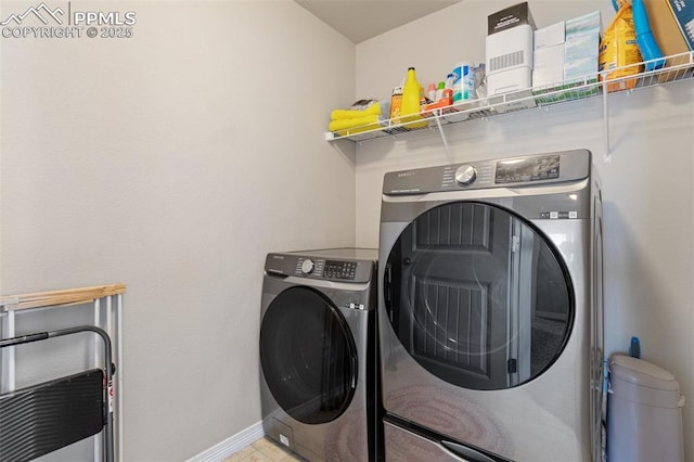 laundry room with baseboards, laundry area, and independent washer and dryer