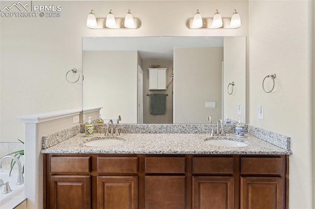 bathroom featuring double vanity, a sink, and a washtub