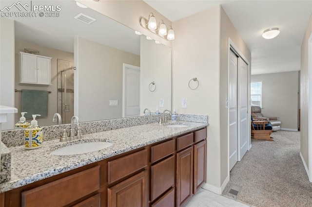 full bath featuring a sink, a stall shower, double vanity, and visible vents
