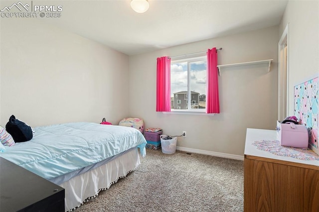 bedroom with carpet floors and baseboards