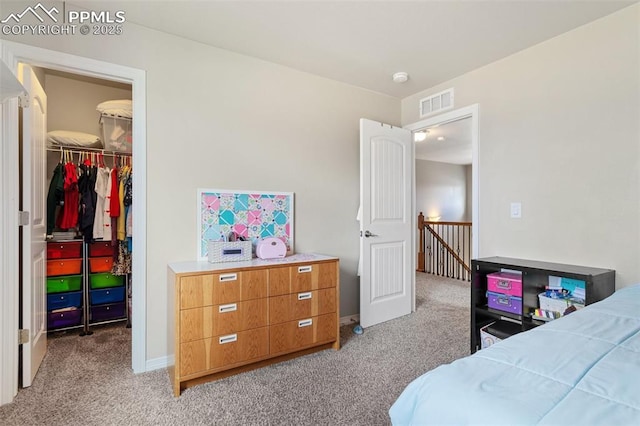 bedroom featuring light colored carpet, a spacious closet, a closet, and visible vents