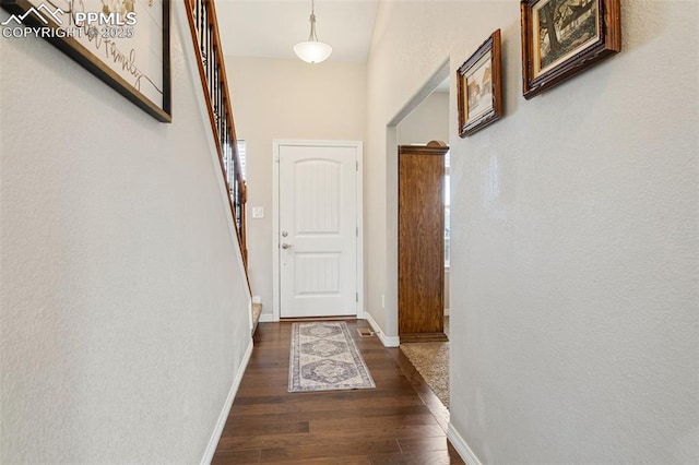 doorway to outside with stairs, baseboards, and wood finished floors