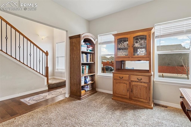 interior space with baseboards, light wood-style flooring, and visible vents