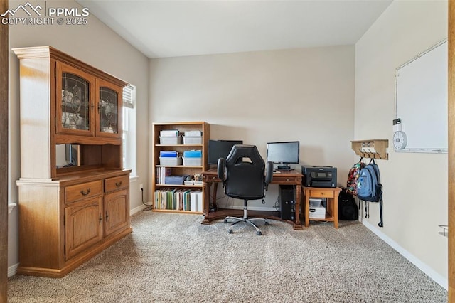 office featuring baseboards and light carpet