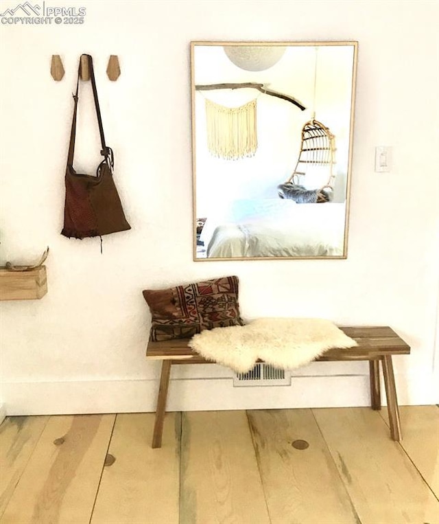 mudroom featuring baseboards and wood finished floors