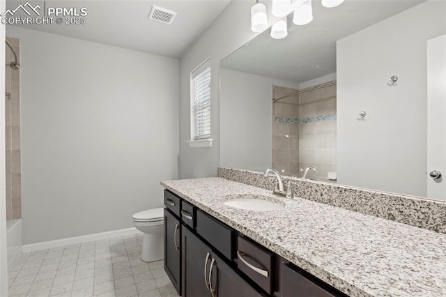 bathroom featuring toilet, baseboards, visible vents, and vanity