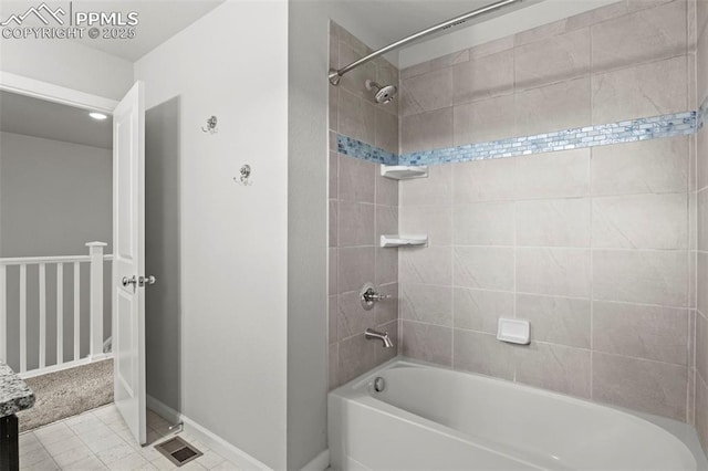full bath featuring baseboards and washtub / shower combination