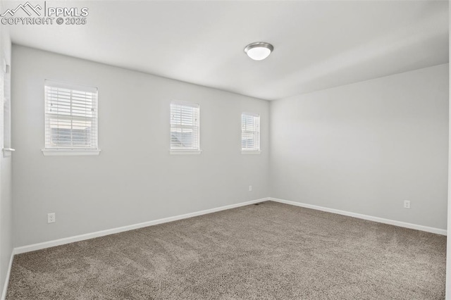 carpeted spare room with baseboards and a healthy amount of sunlight