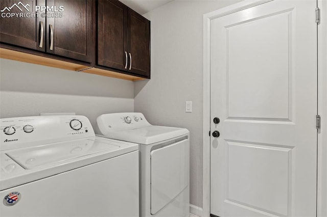 laundry room with washing machine and dryer and cabinet space