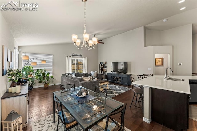 6647 Weiser Dr, Colorado Springs, CO 80925 - dining room featuring baseboards, vaulted ceiling, dark wood finished floors, and an inviting chandelier