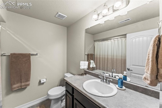 6647 Weiser Dr, Colorado Springs, CO 80925 - full bath with visible vents, baseboards, toilet, and vanity