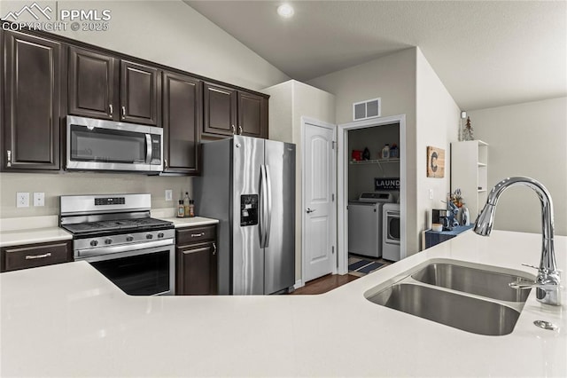 6647 Weiser Dr, Colorado Springs, CO 80925 - kitchen with visible vents, a sink, light countertops, stainless steel appliances, and washer and dryer