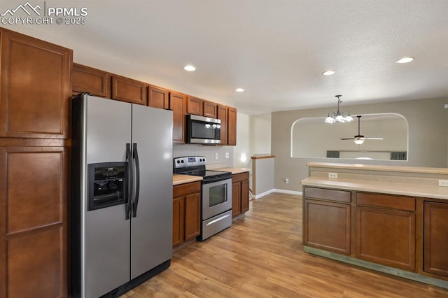 kitchen with recessed lighting, light countertops, a chandelier, and stainless steel appliances