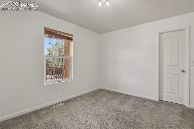 unfurnished room with carpet flooring, baseboards, and visible vents