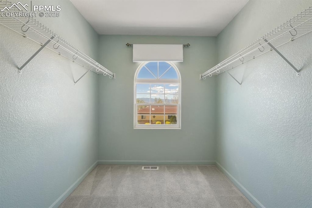 walk in closet with carpet floors and visible vents