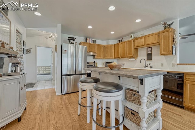 16440 Eastonville Rd, Elbert, CO 80106 - kitchen featuring freestanding refrigerator, black dishwasher, under cabinet range hood, light wood-style flooring, and recessed lighting